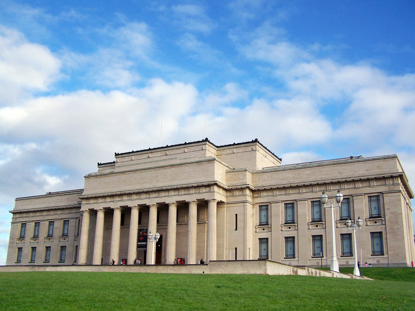 the front side of a large building with a staircase going up to the top