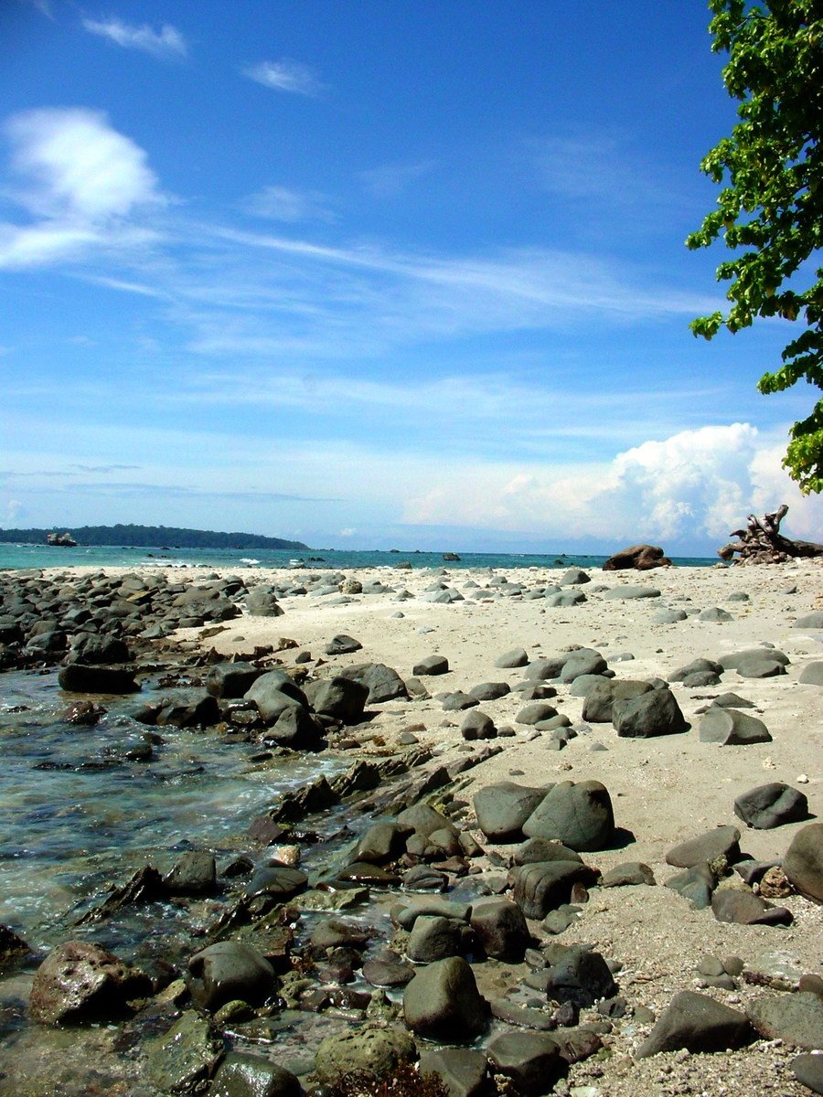 the shore is covered in some rocks and pebbles