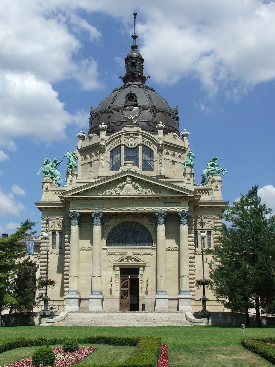 a large building with some statues on the top of it