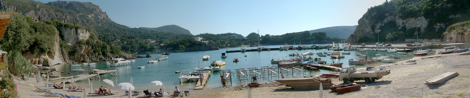 several boats in a bay next to some cliffs