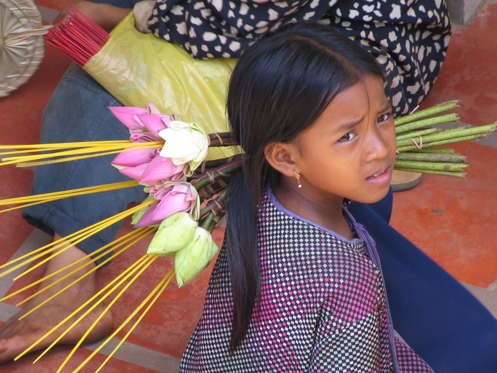 a girl with a flower on her hair with long hair