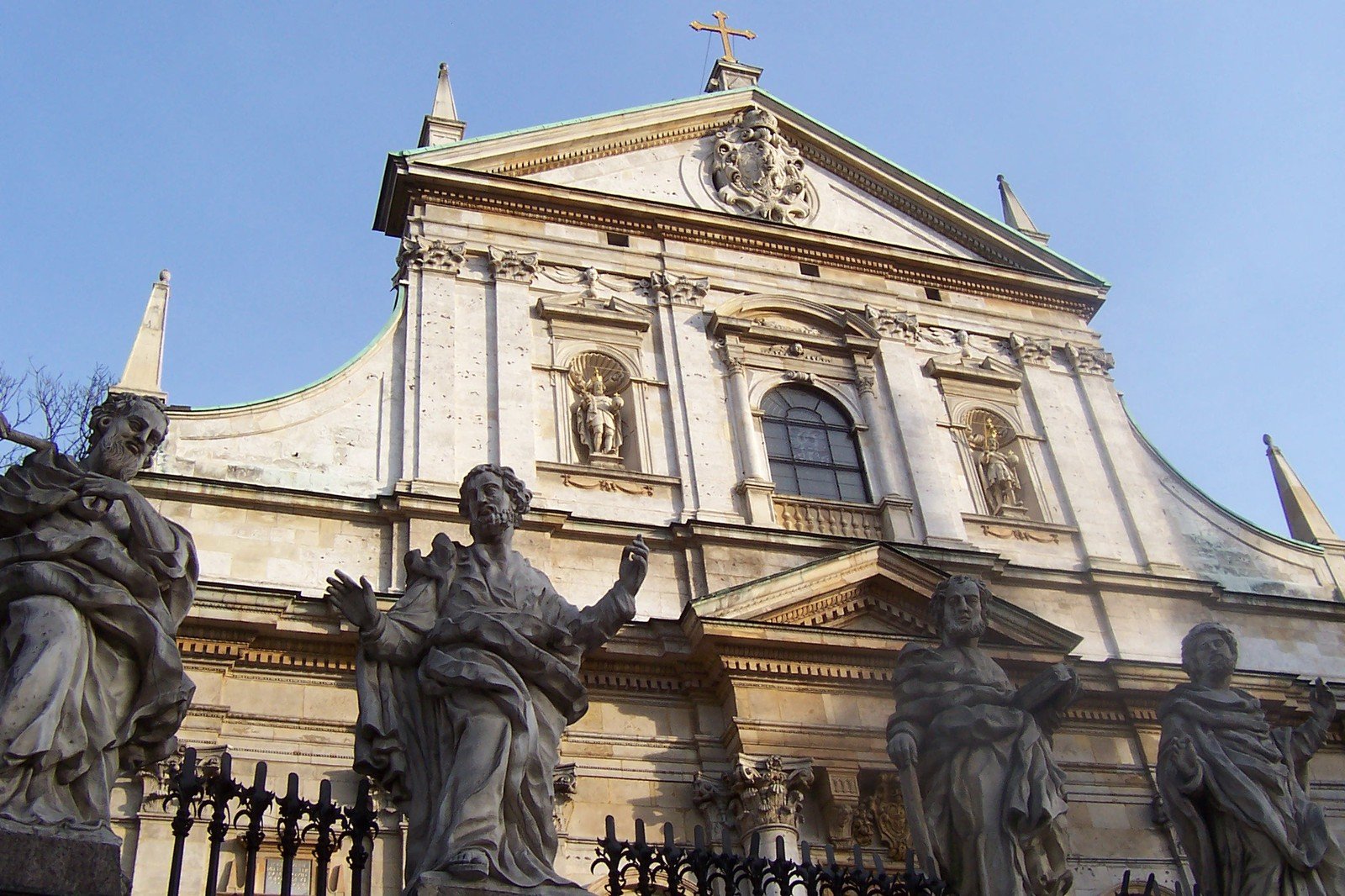 statues of men, women and children in front of a building