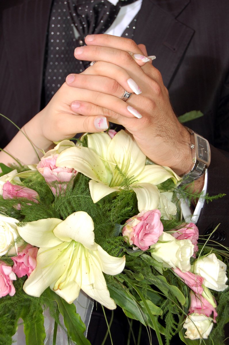 man holding bunch of flowers wearing ring over finger