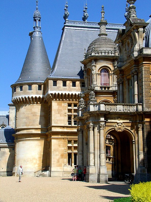 a very old style building sitting on a street