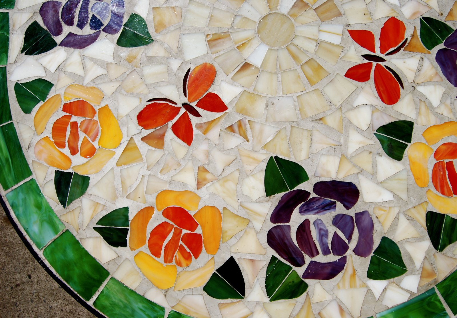 a multi colored flower design mosaic on a tile slab