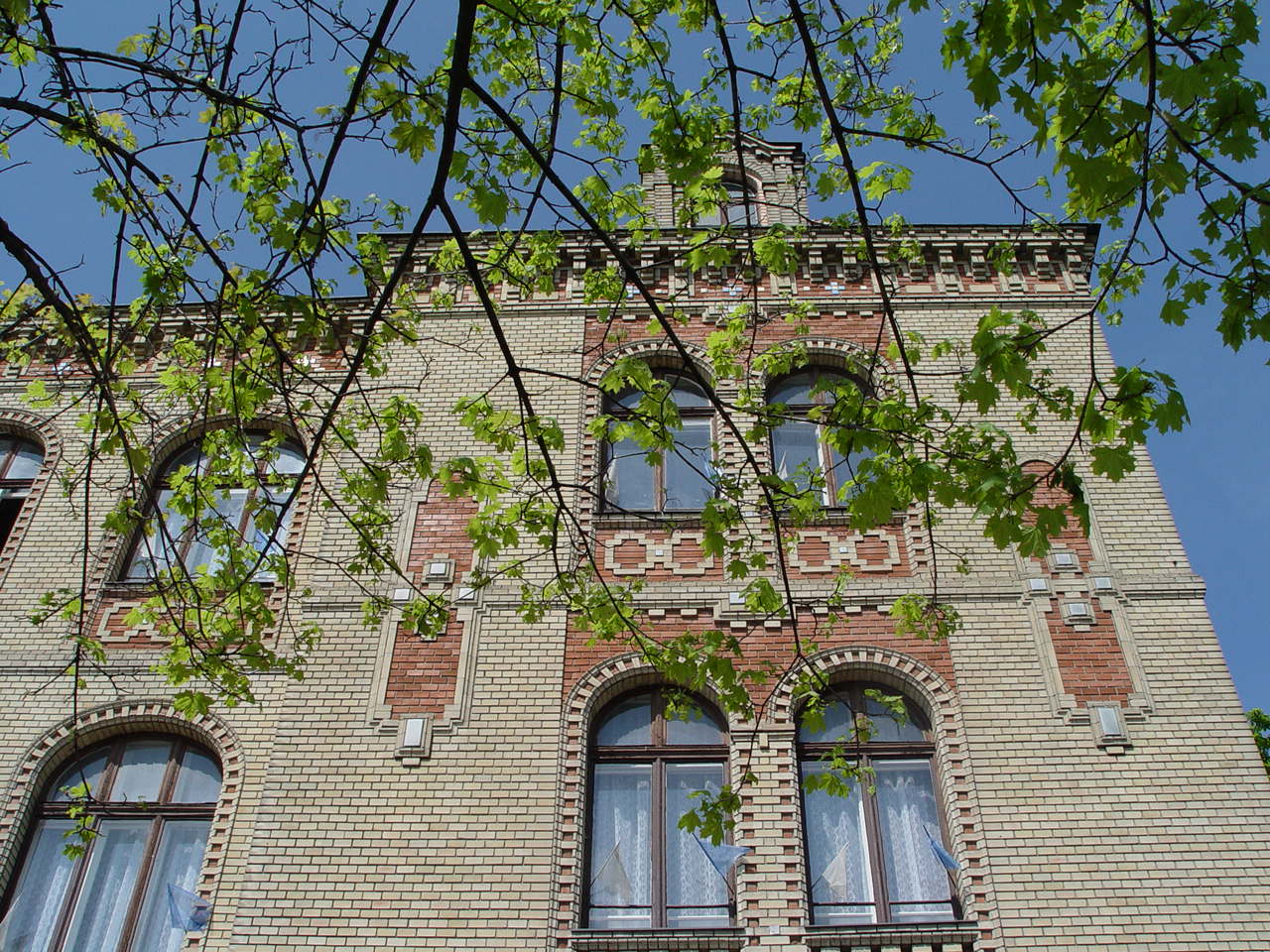 a tall brick building with multiple windows
