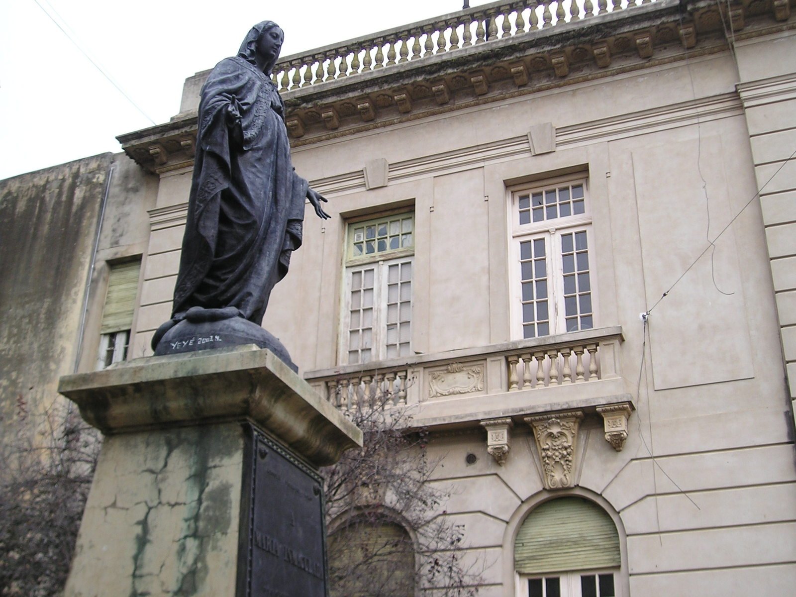 an elegant statue sitting in front of a building