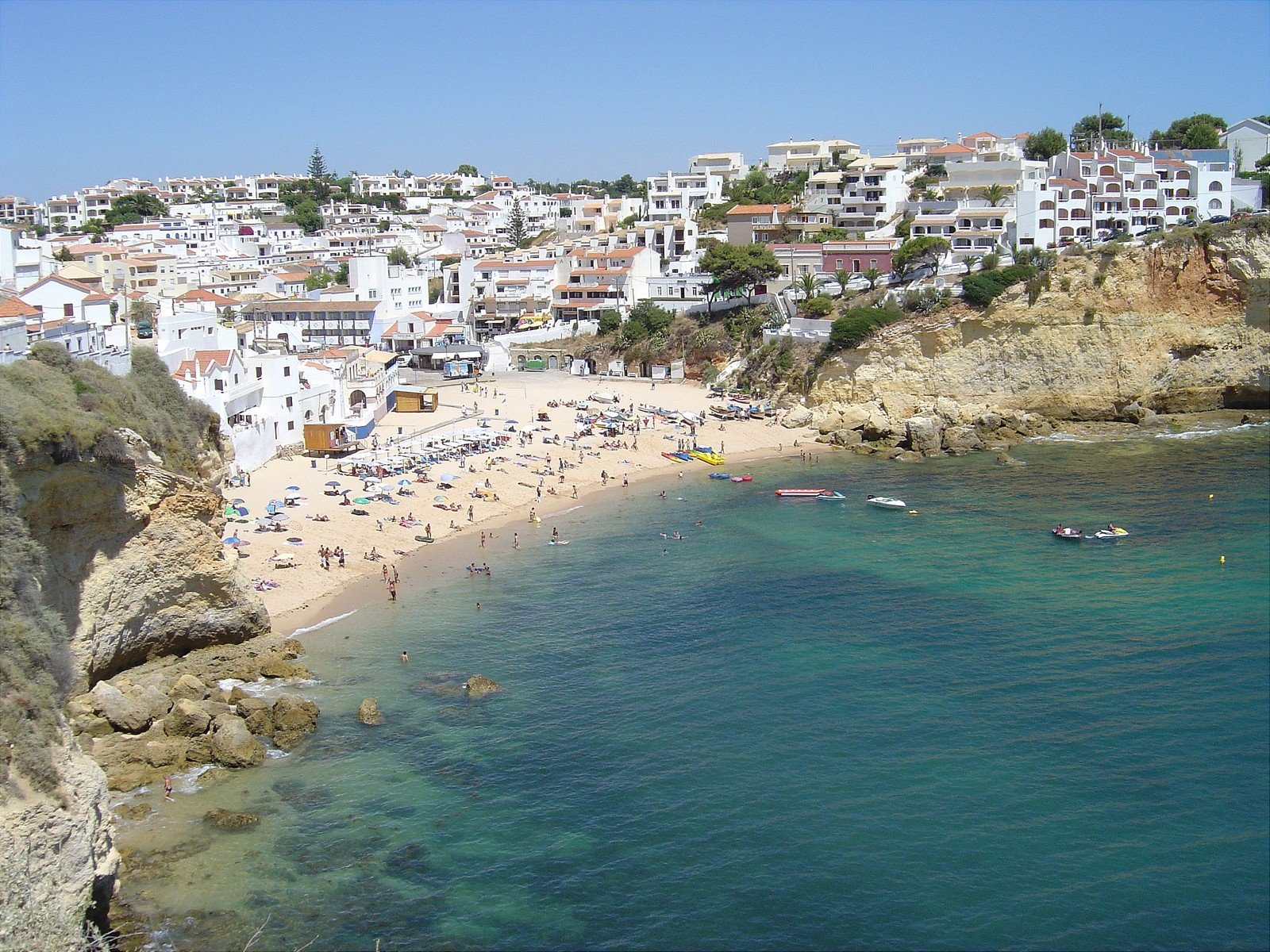 a beach next to a city near the water