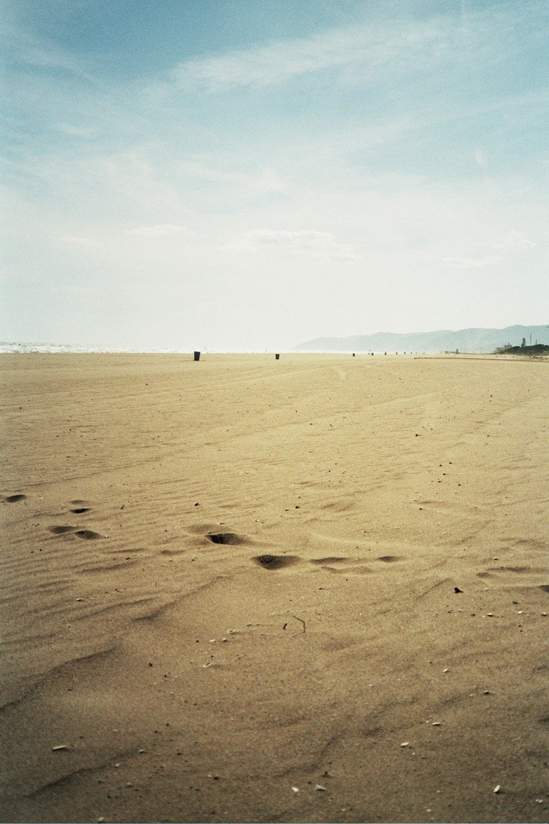footprints in the sand on an open area