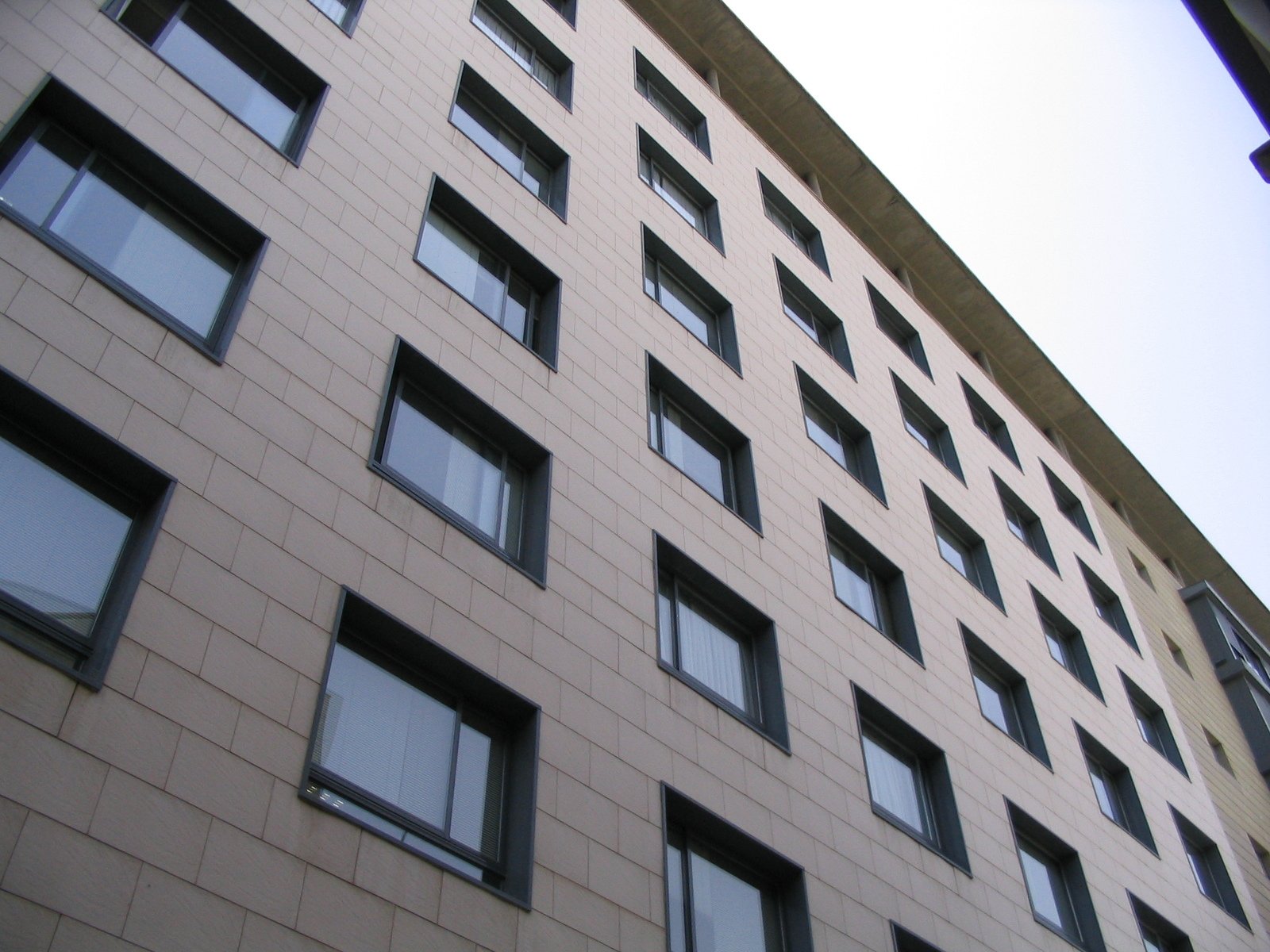 an older building is shown with many windows