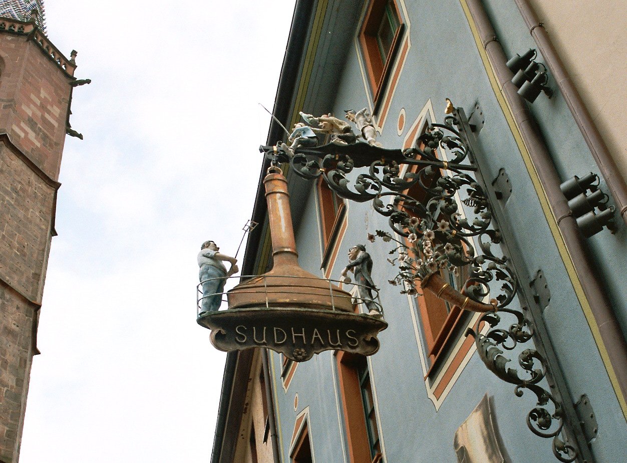 street light in front of old buildings against blue sky