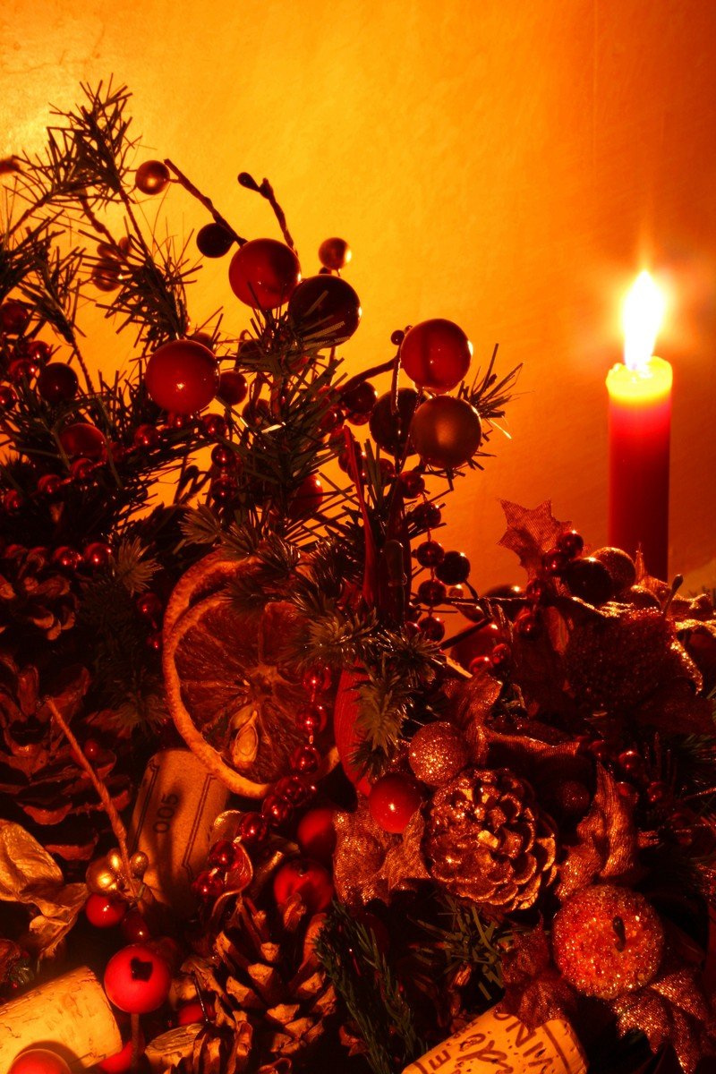 a small assortment of objects next to a lit candle