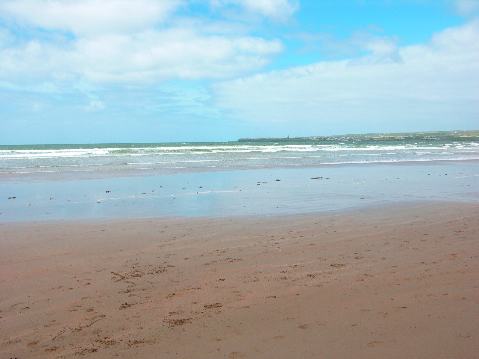 a beach that has a blue sky and some water