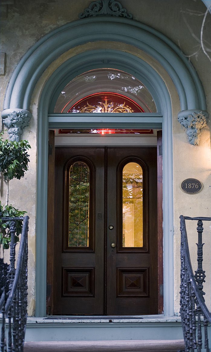 an entrance to a house that has two doors