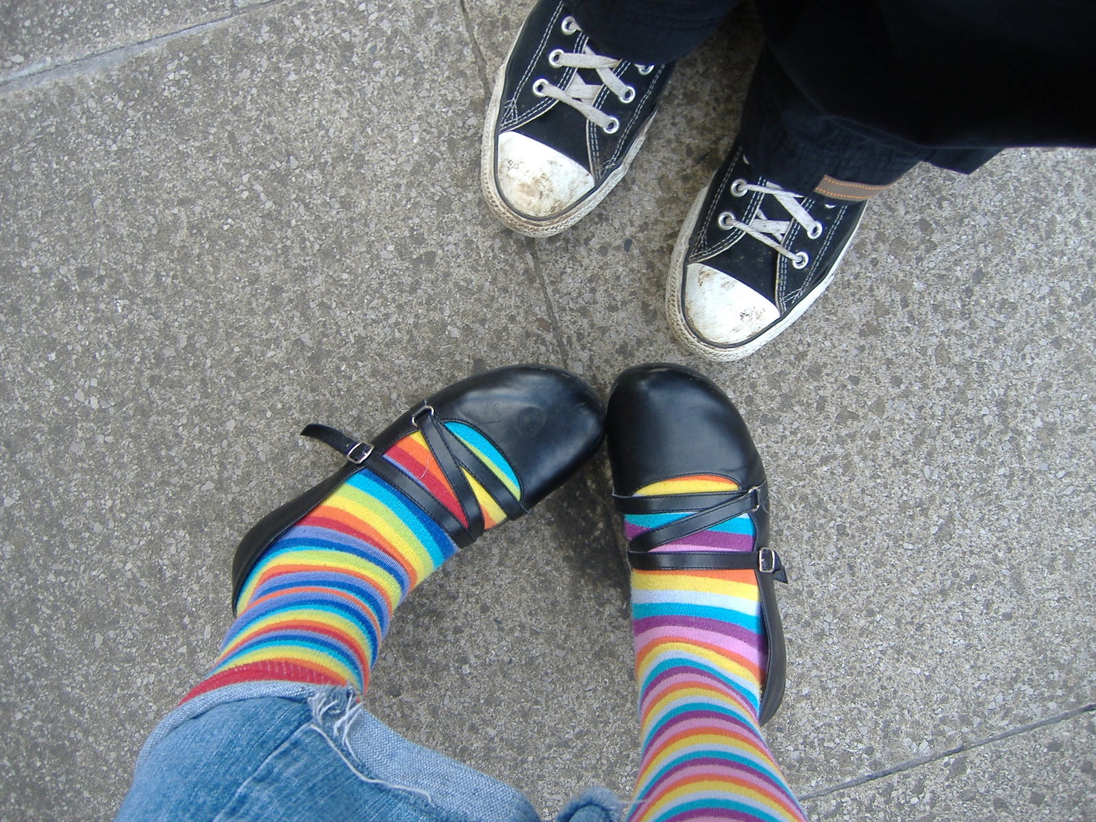 a pair of feet wearing colorful striped socks