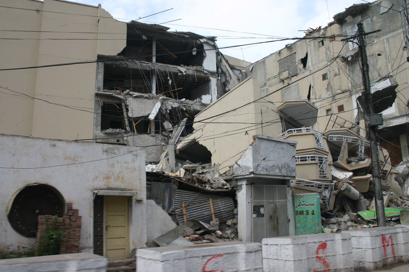 the demolished building with red graffiti has been vandalized