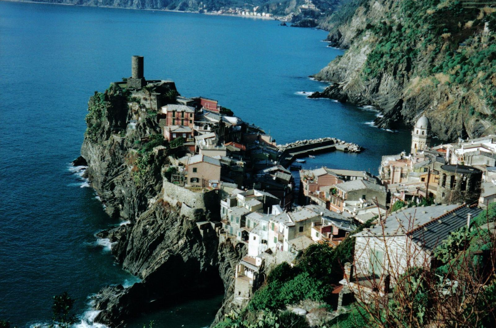 a village nestled on a small cliff overlooking the water