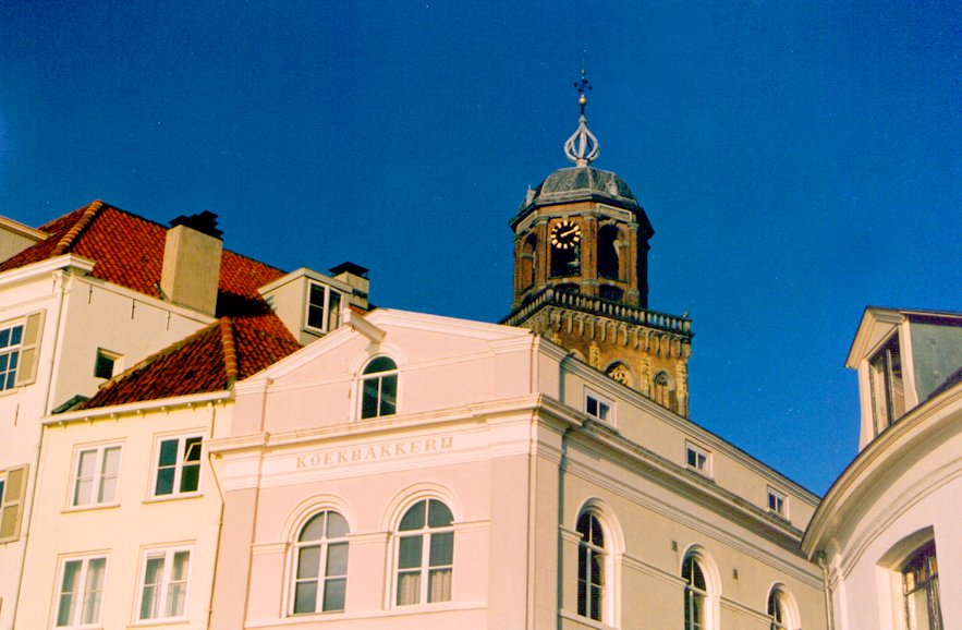 a clock tower is next to some buildings