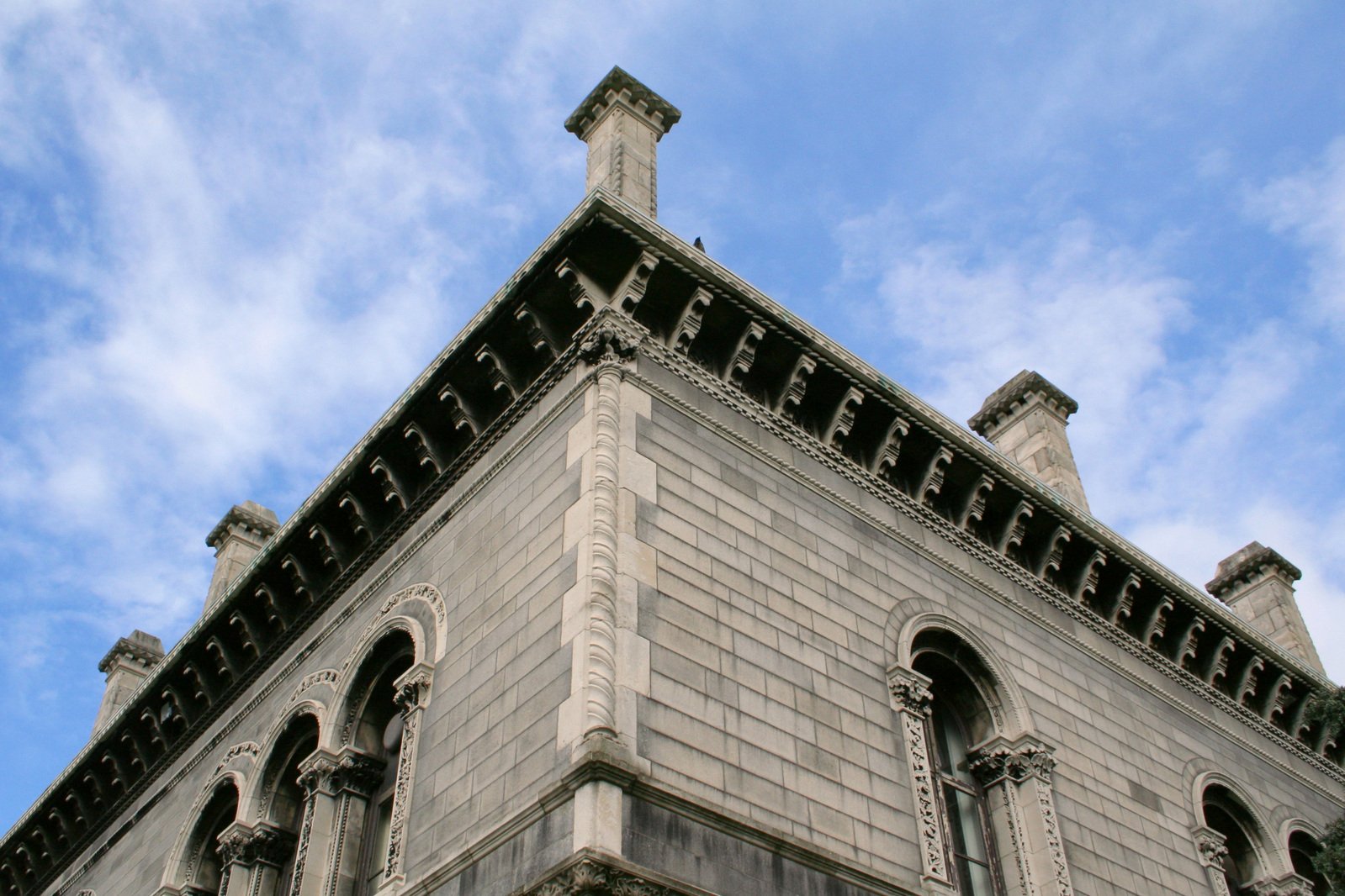 a tall tower with ornate gargoyles on the top