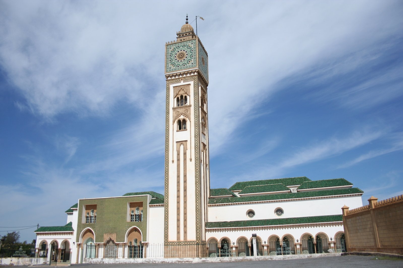 a very tall clock tower near other buildings