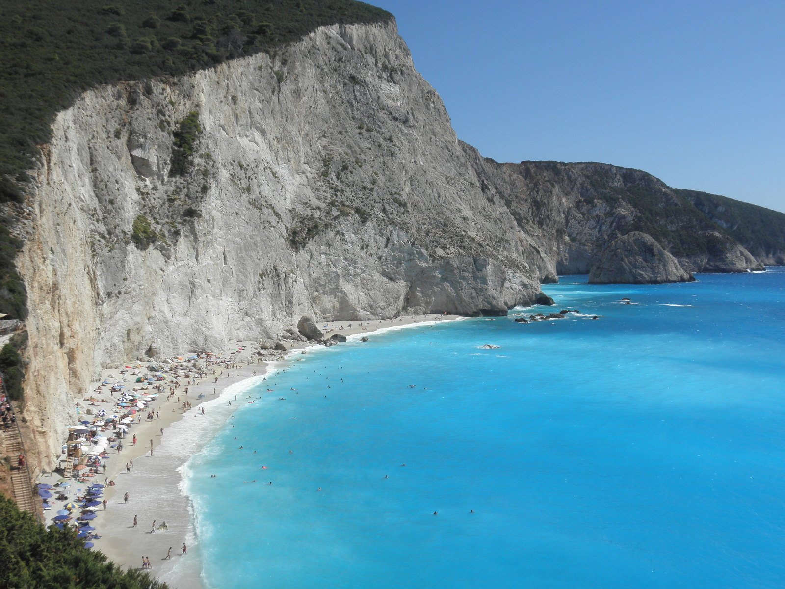 several beach filled with people and large mountain