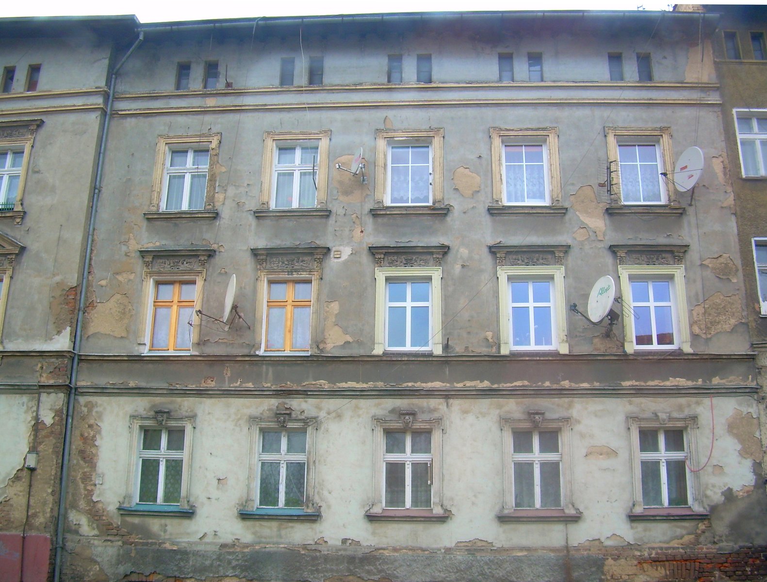 old buildings with boarded windows on the wall