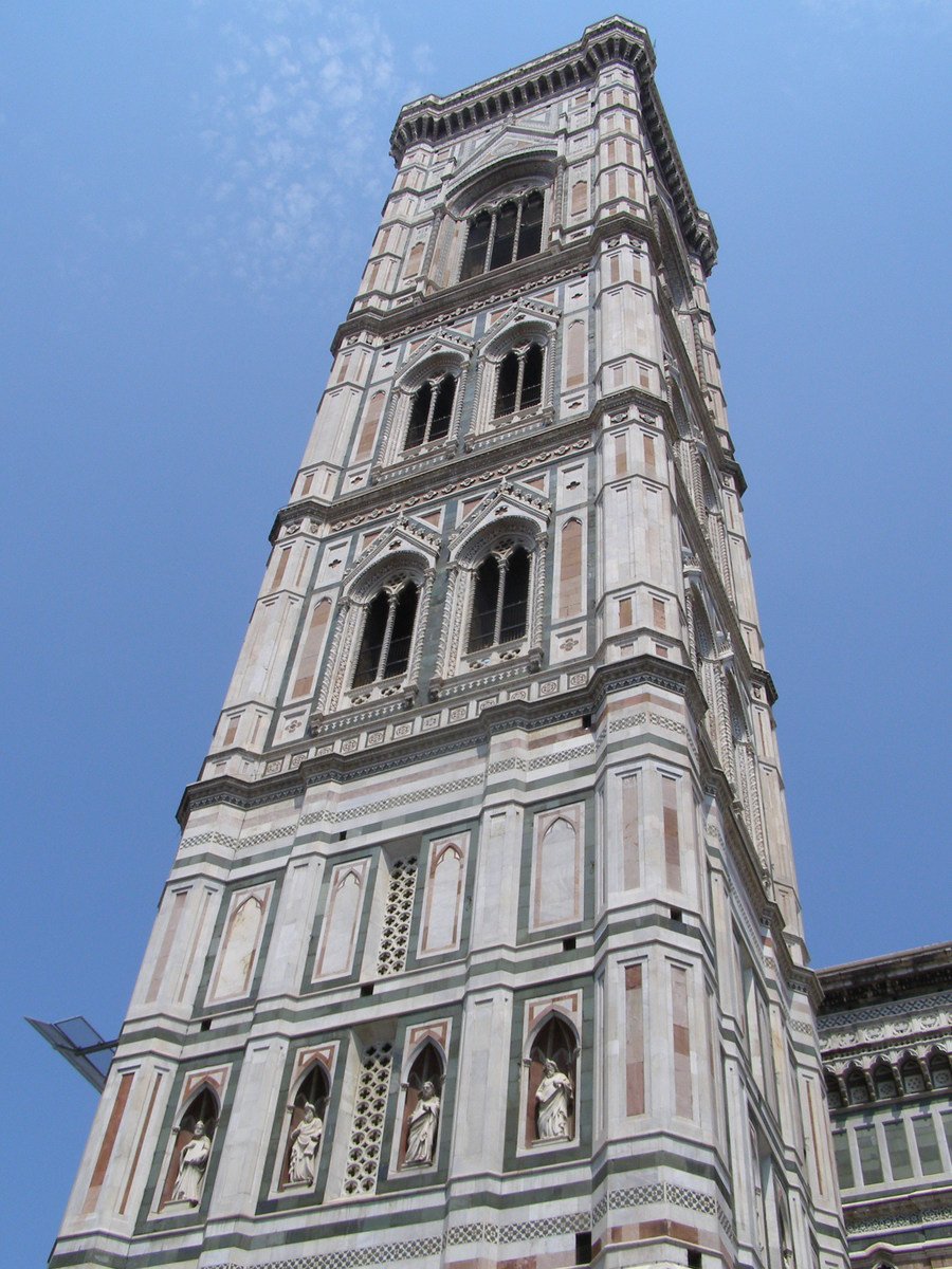 a large tower with clock faces on a clear day