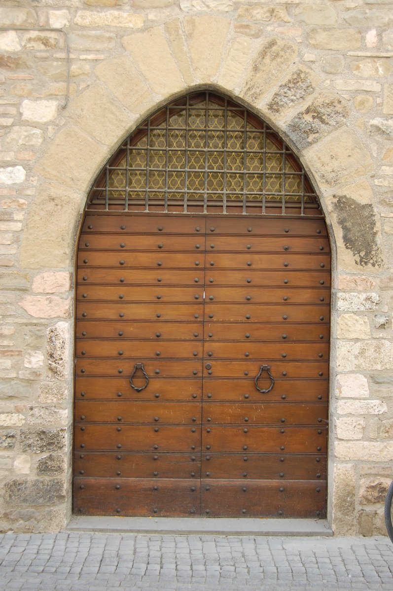 the large wooden gates are open to reveal an archway