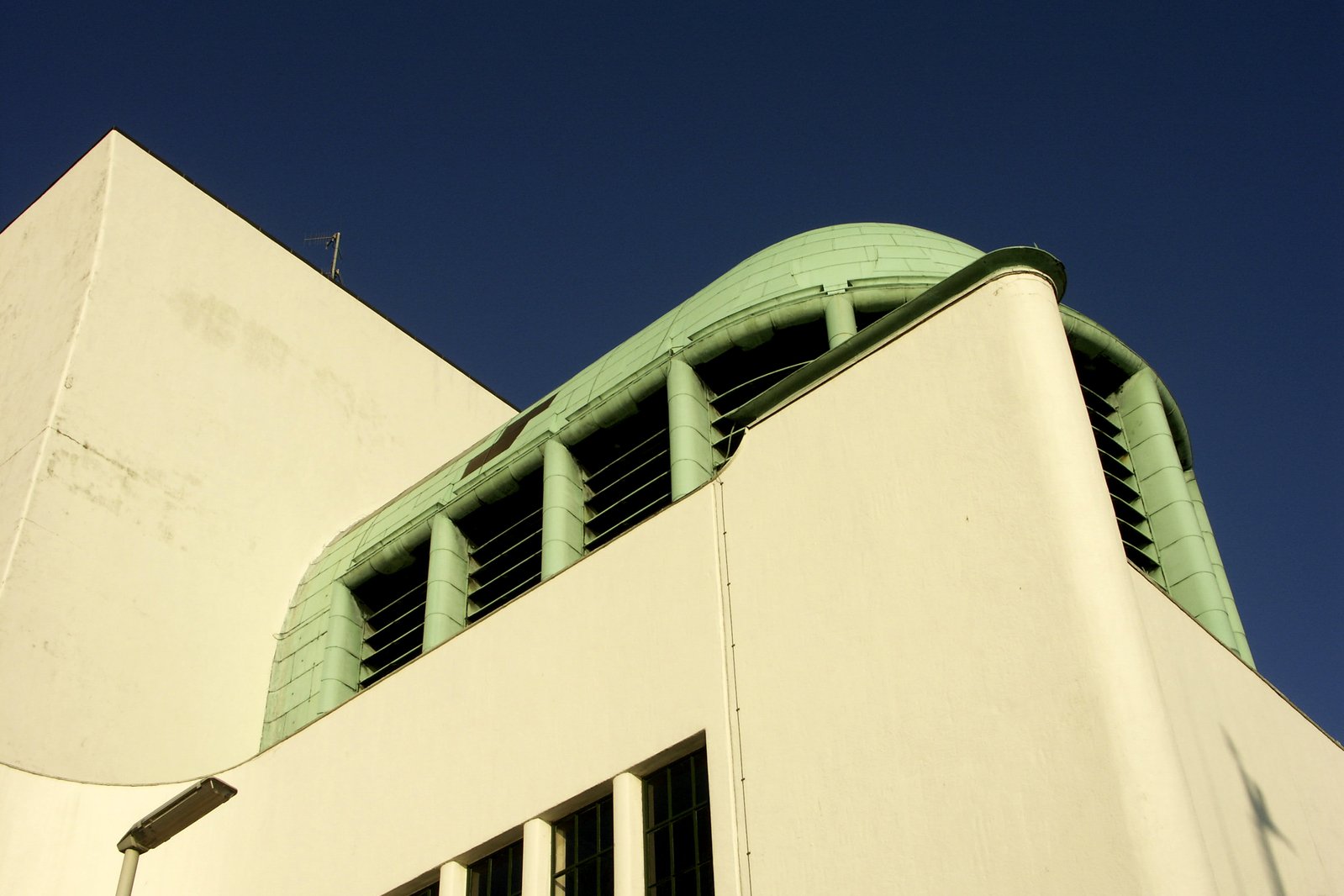 there is a small bird on the roof of a building