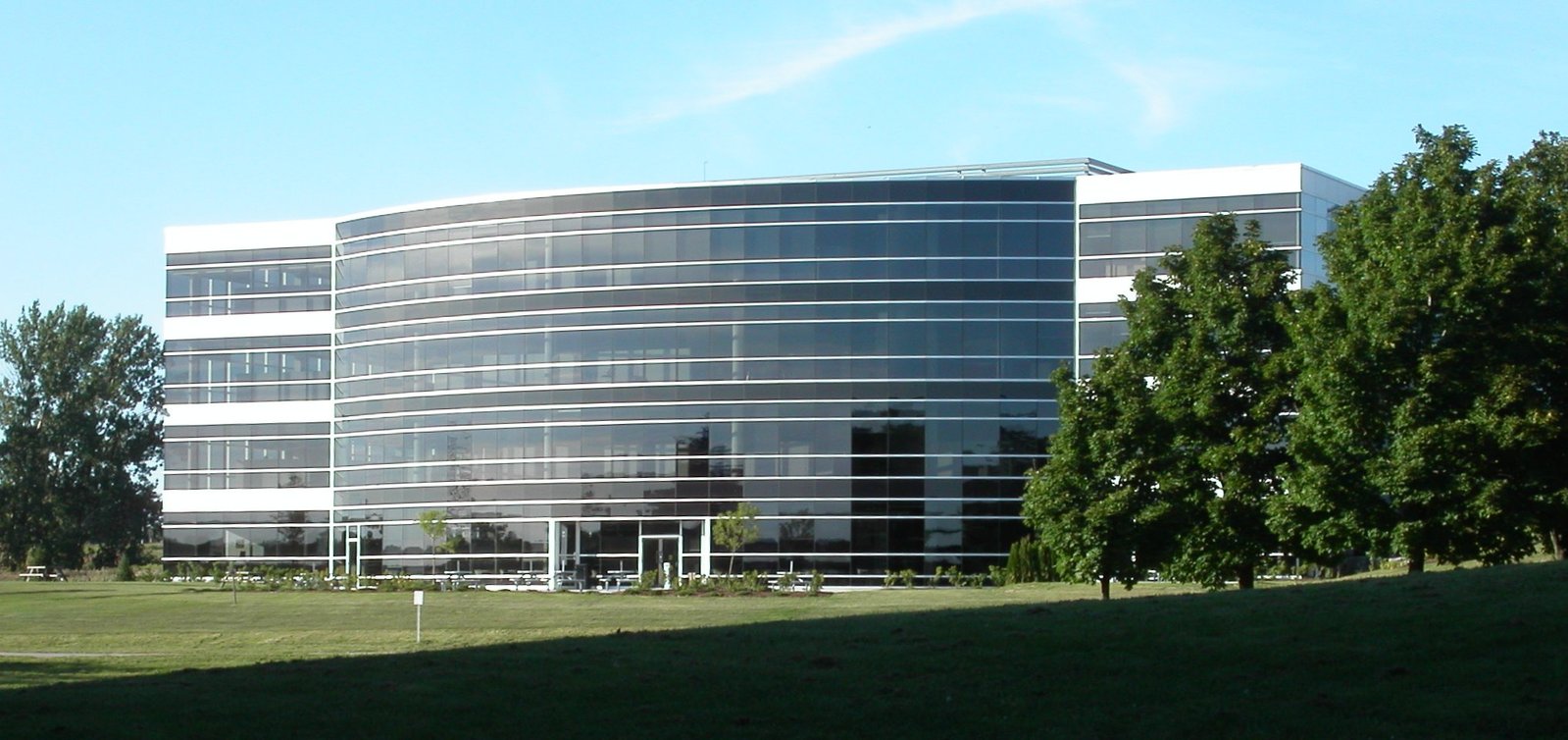 the large building is next to the grassy area