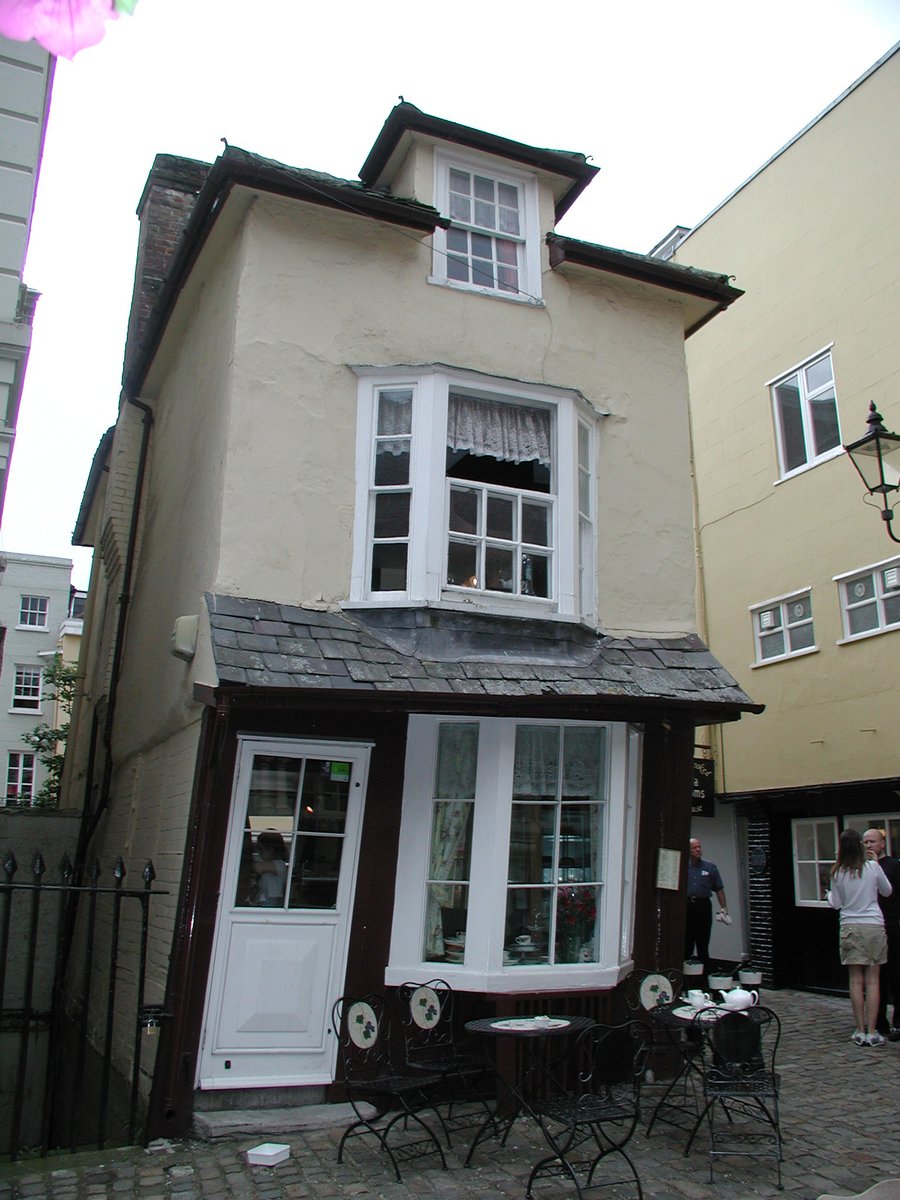 a couple of people stand near a house