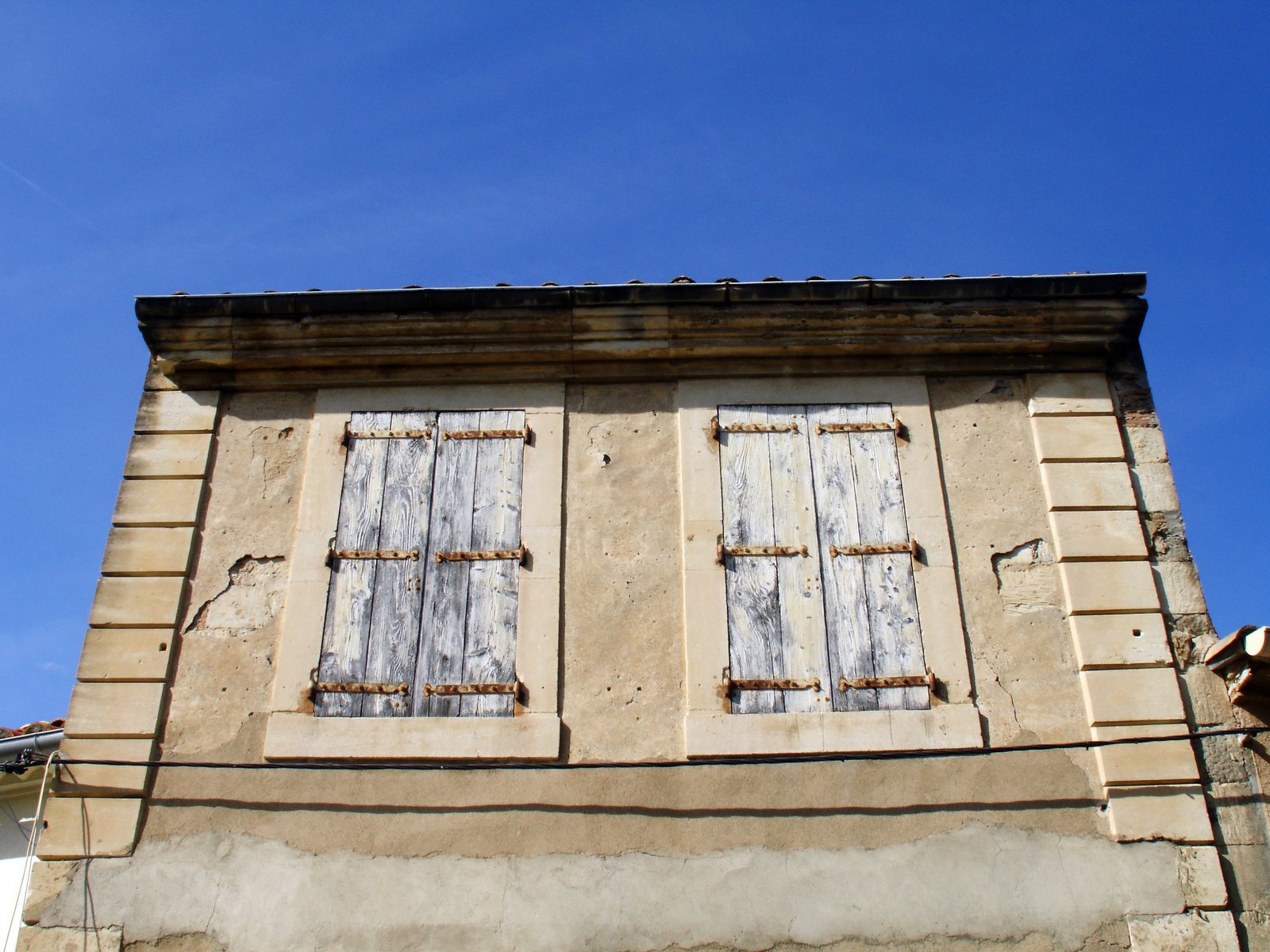 a building with a closed door and two windows