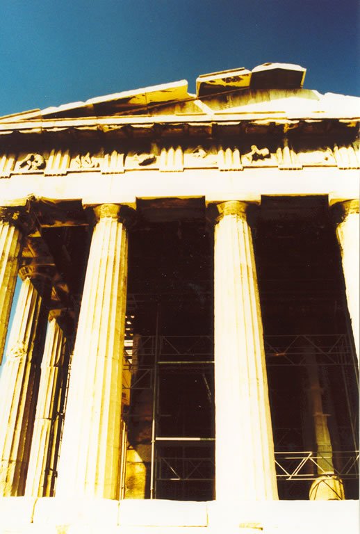 a large old building with pillars and arches in it