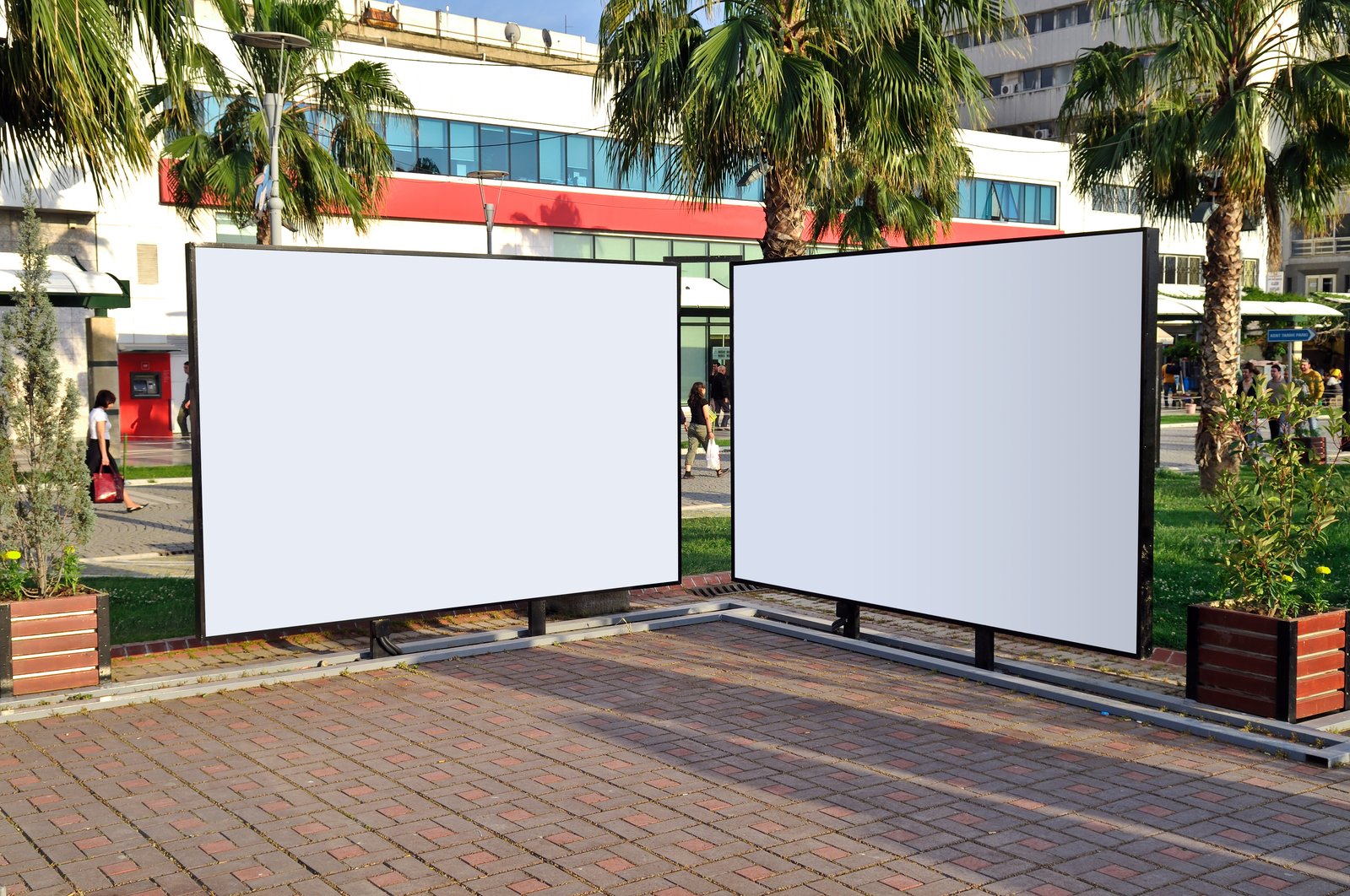 two blank billboards in front of a building