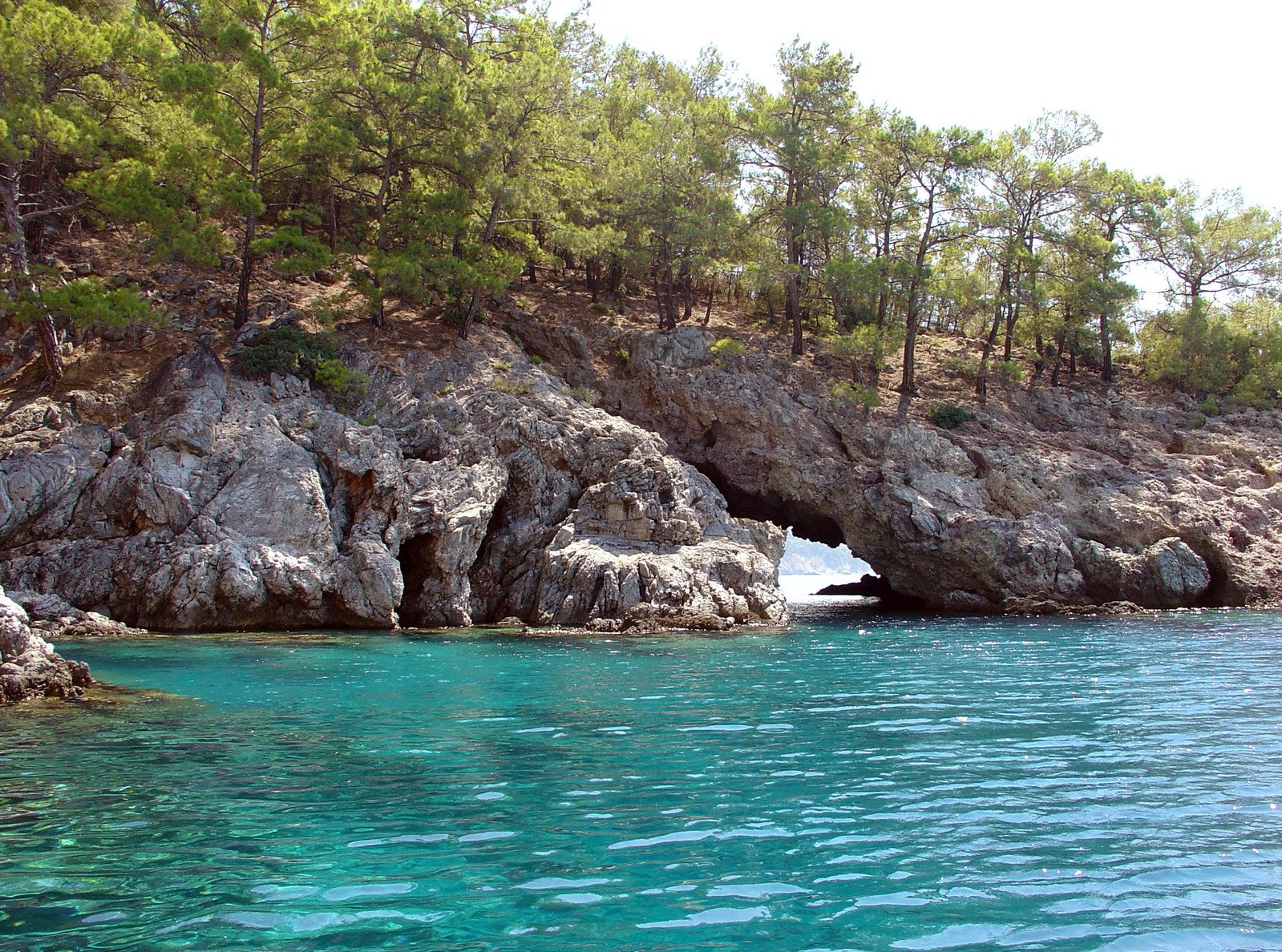 a large rock formation sticking out of the ocean