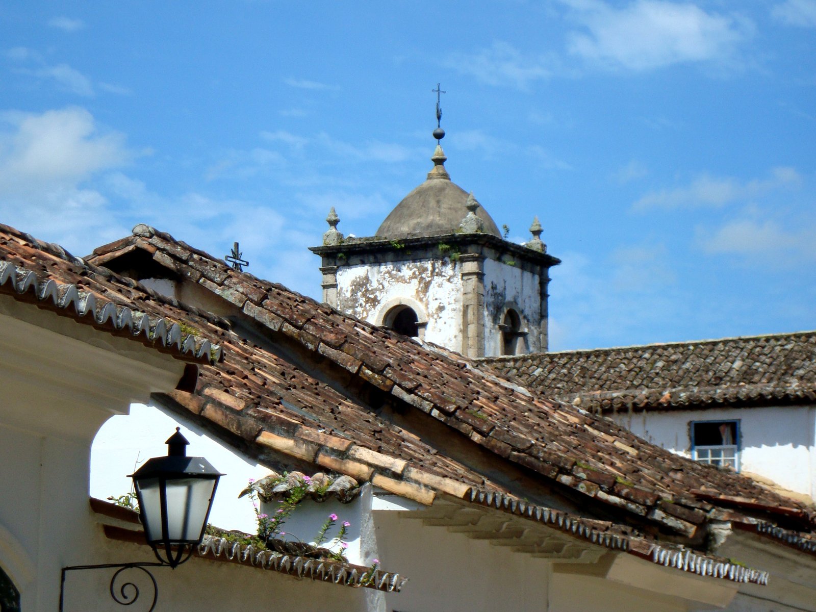 the top of an old building with tiled roof