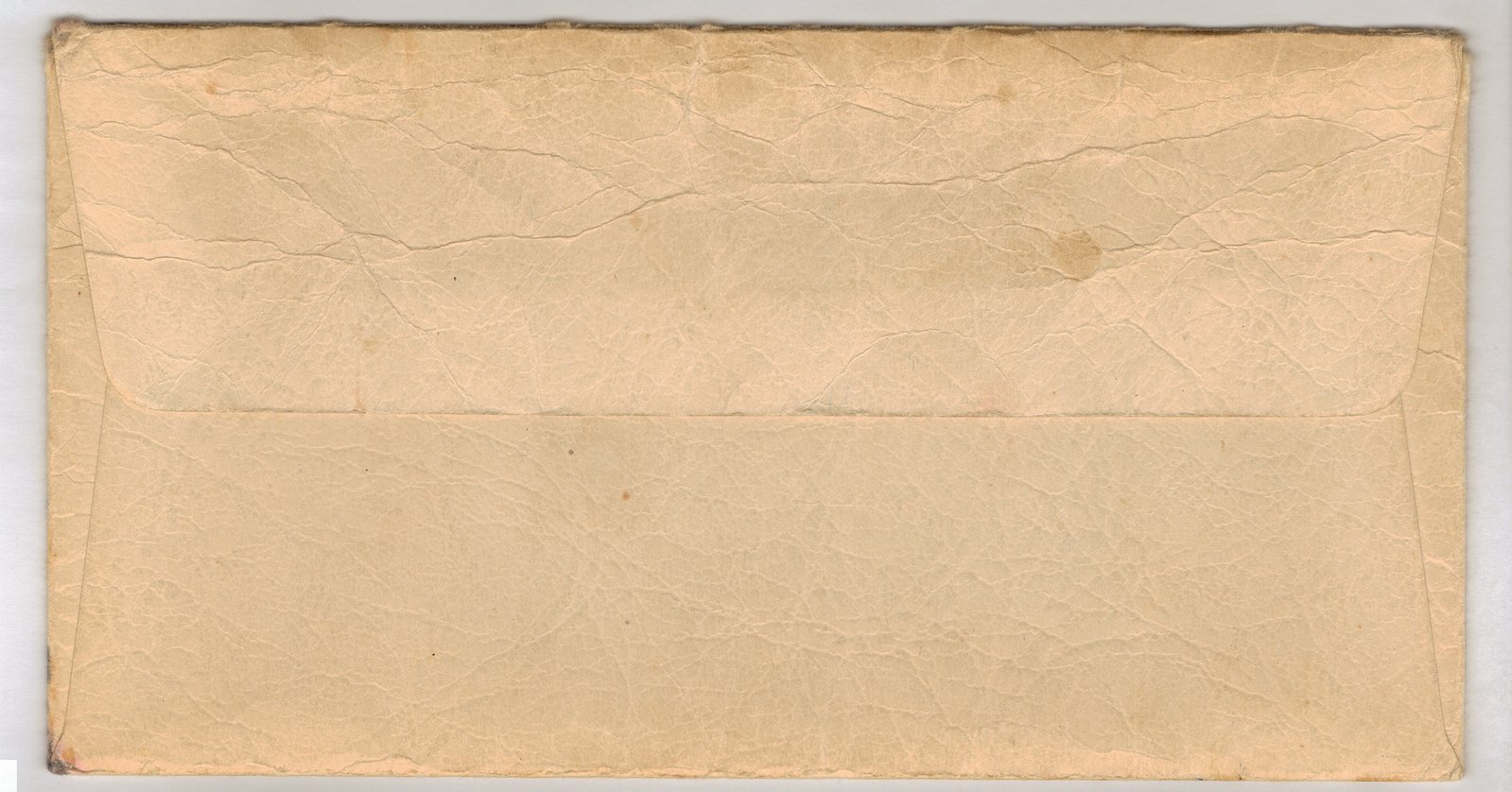 a beige torn paper envelope is shown in a box