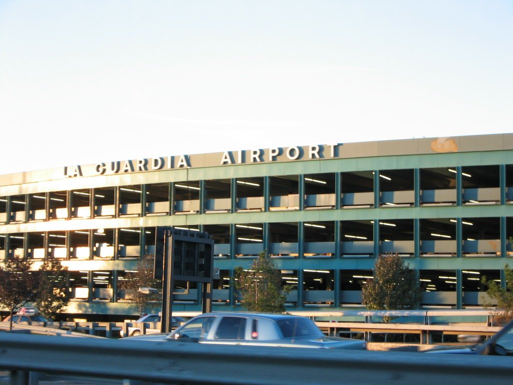 a very big building with some cars in front