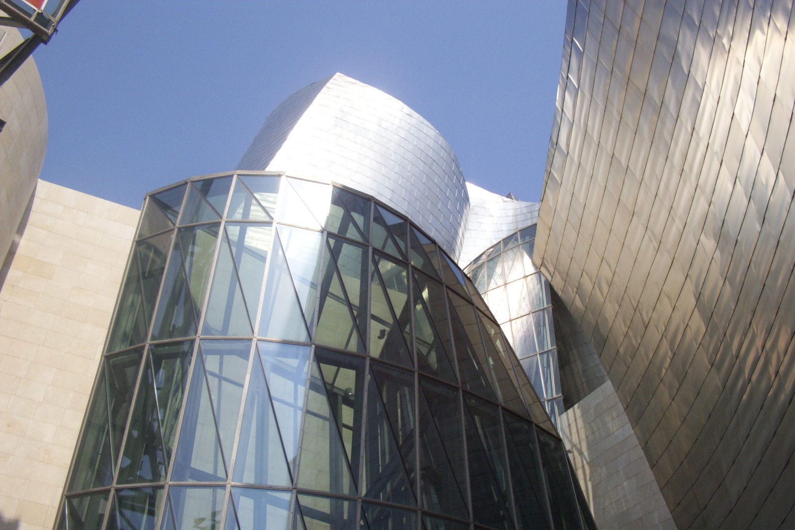 curved glass and steel building against the blue sky