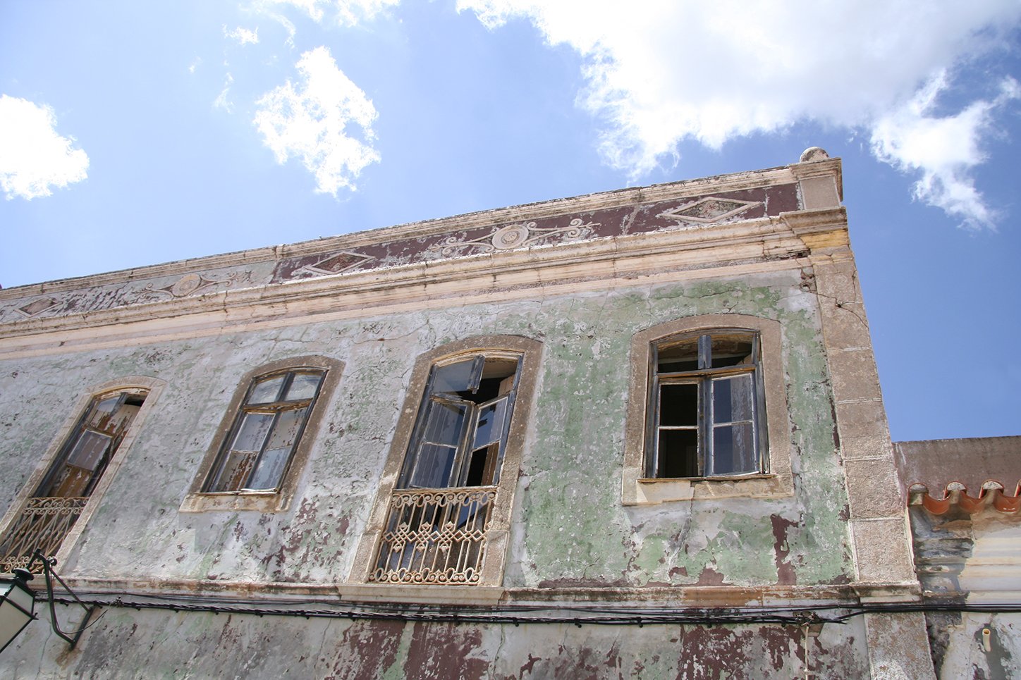 an old building with windows and a balcony