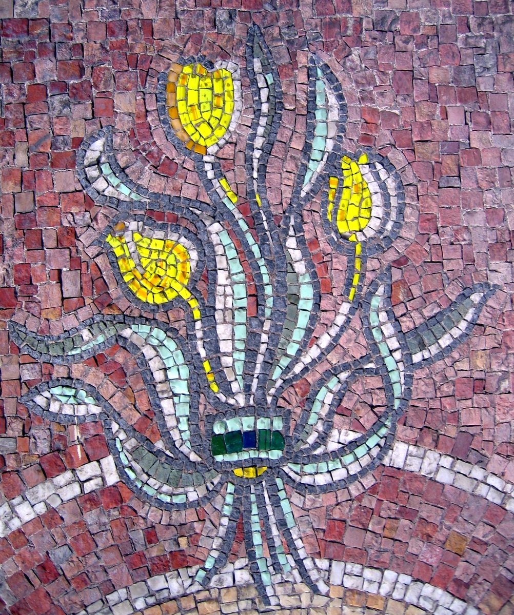 a mosaic design with yellow flowers and grey ground