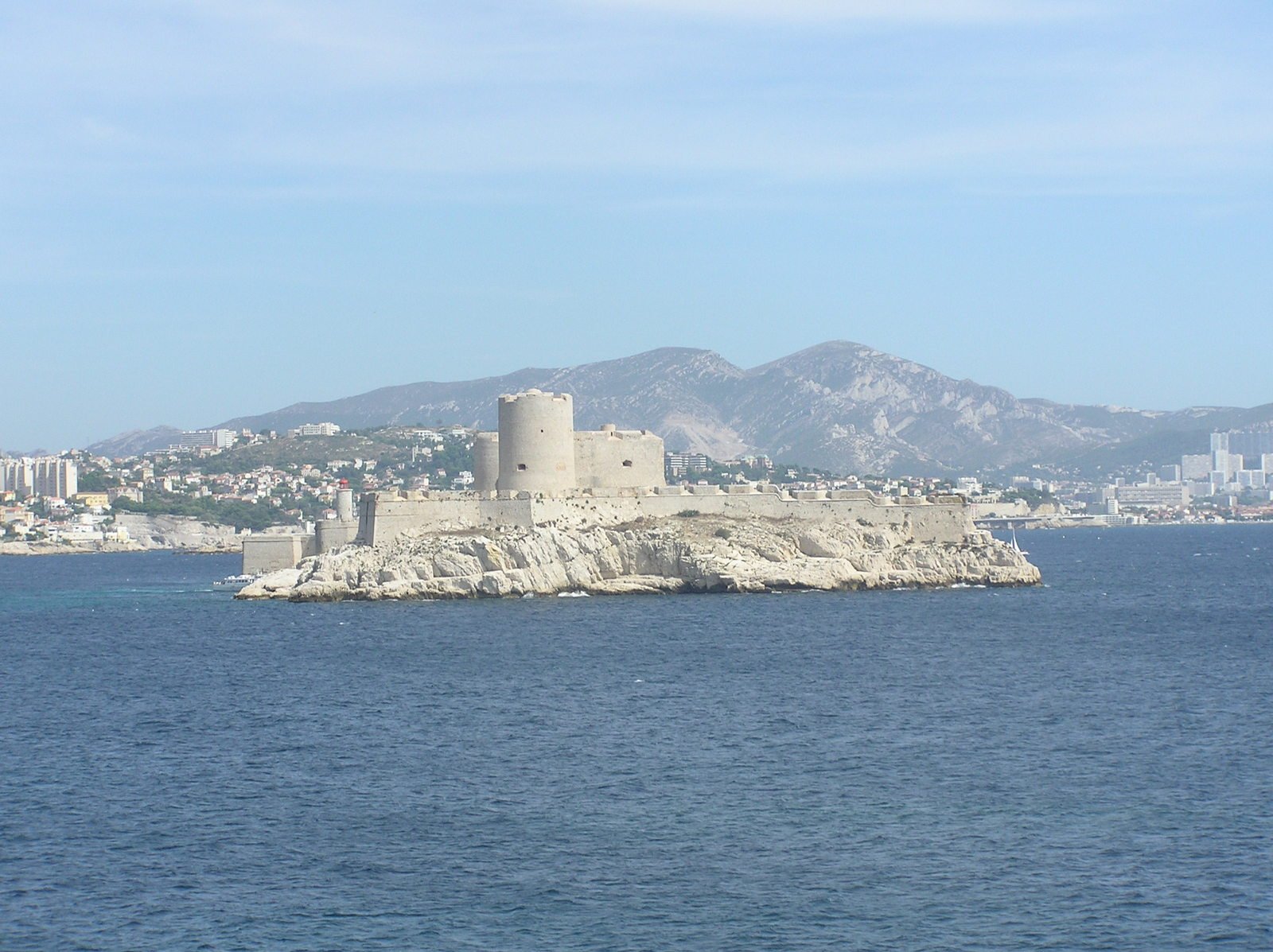 a white castle sitting in the middle of the ocean