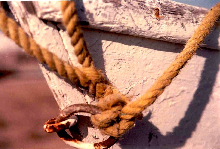 an old boat is roped down and ready to be hung on a wall