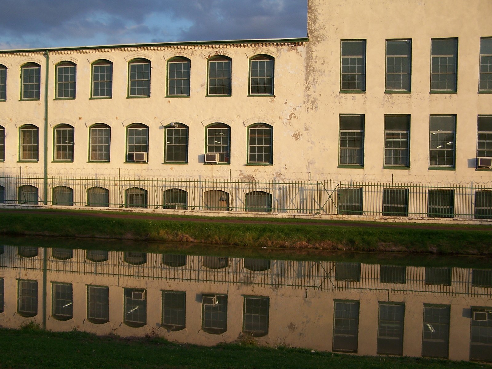 a building near a body of water with many windows