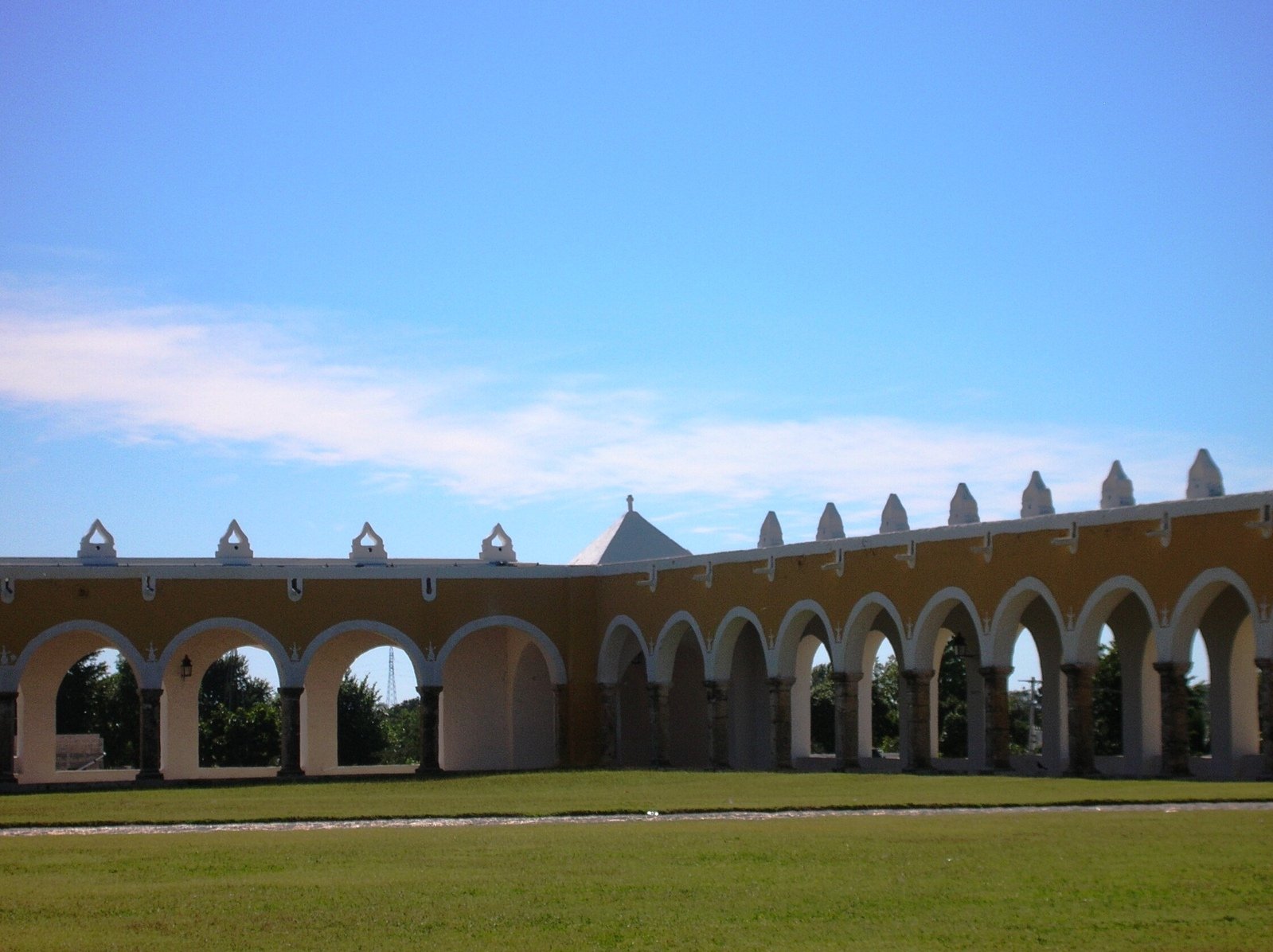 an open area in front of a building with arches on top