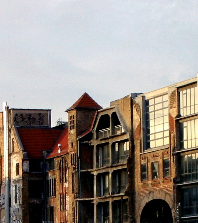 a large building sitting in front of a water way