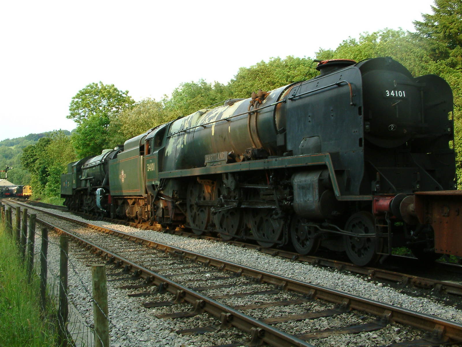 a train on the tracks moving around a bend