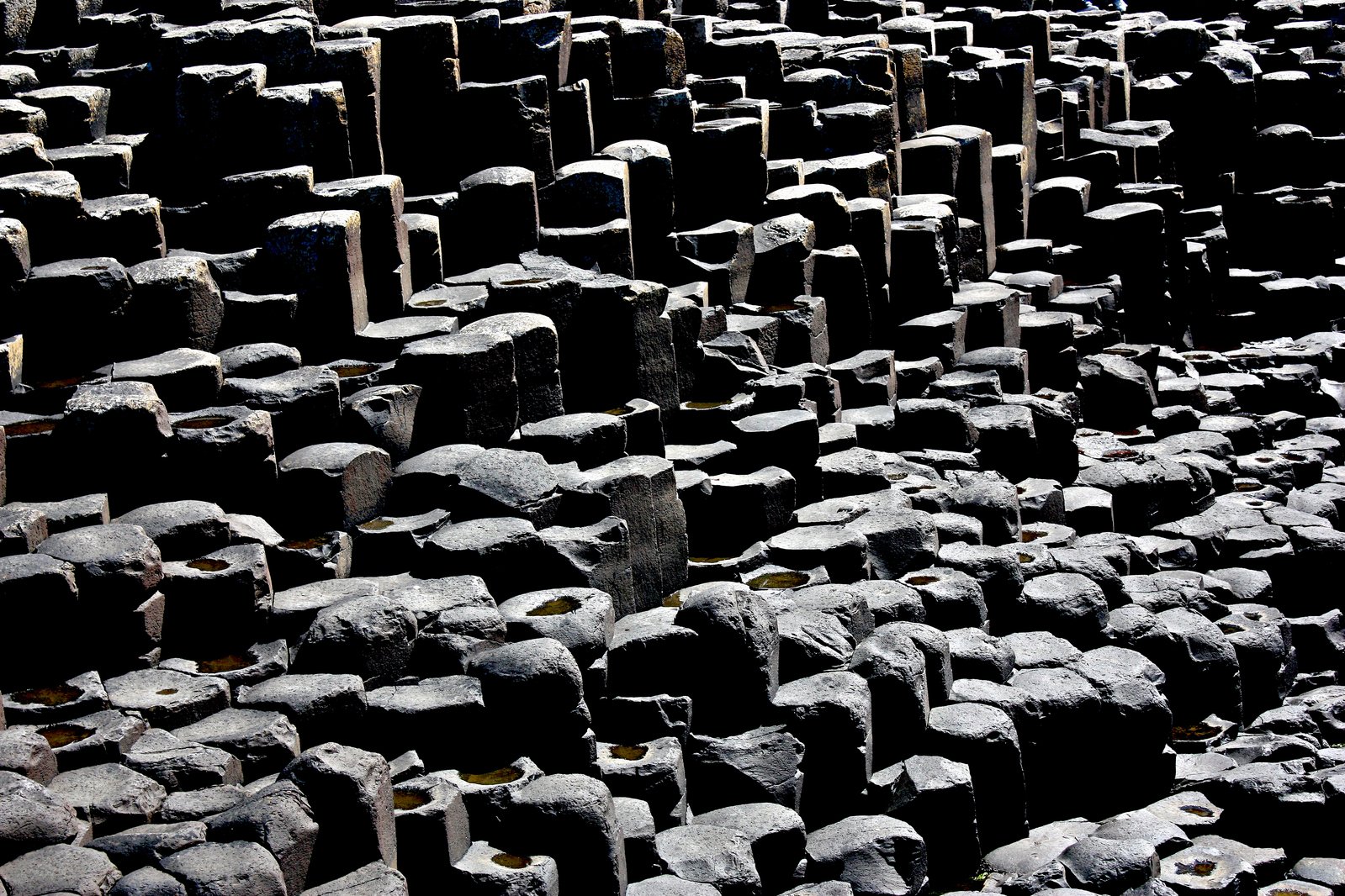 the large group of black stone bricks has rows of smaller rocks