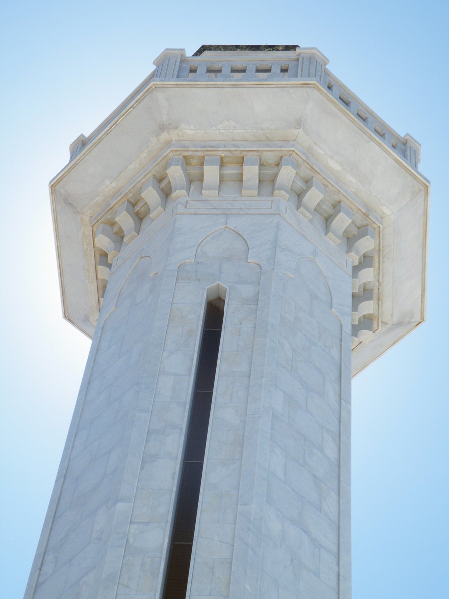 a tall tower with a clock on it's side