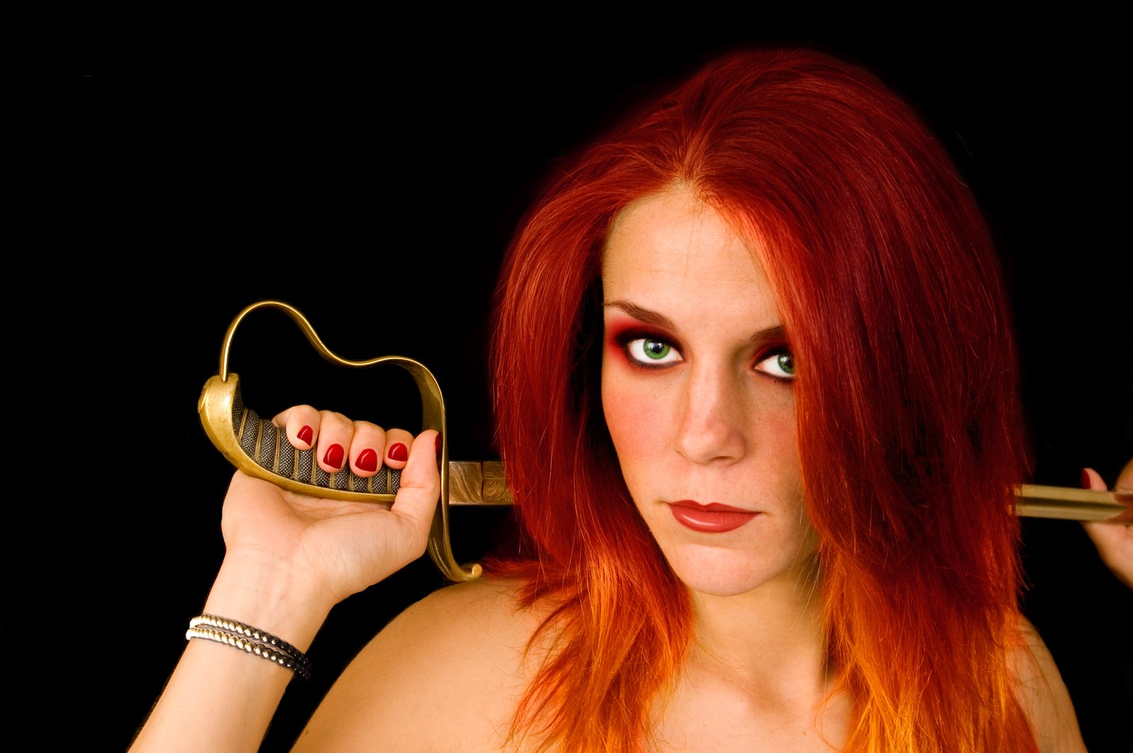 an image of a woman with long red hair and some key in her hand